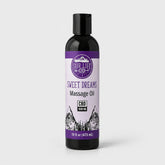 A 16 fl oz black bottle of Our Life CBD Sweet Dreams Massage Oil with a purple and white label, set against a light gray background.