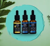 Three bottles of Calm CBN Oil with droppers on a green background