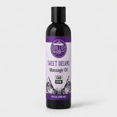 Bottle of 'Sweet Dreams' massage oil with a purple label on a white background