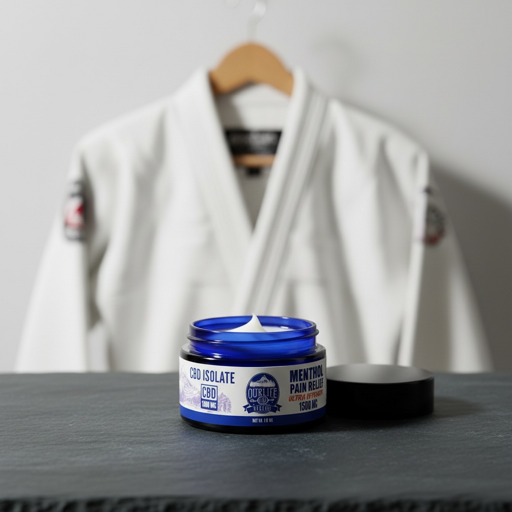 Jar of CBD isolate cream on a table with a white martial arts uniform in the background