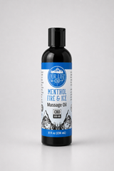 An 8 fl oz bottle of Our Life CBD Massage Oil with Menthol, Fire & Ice, in a dark amber bottle with a black cap and a blue and white label, set against a light gray background.