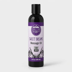 Bottle of 'Sweet Dreams' massage oil with a purple label on a white background