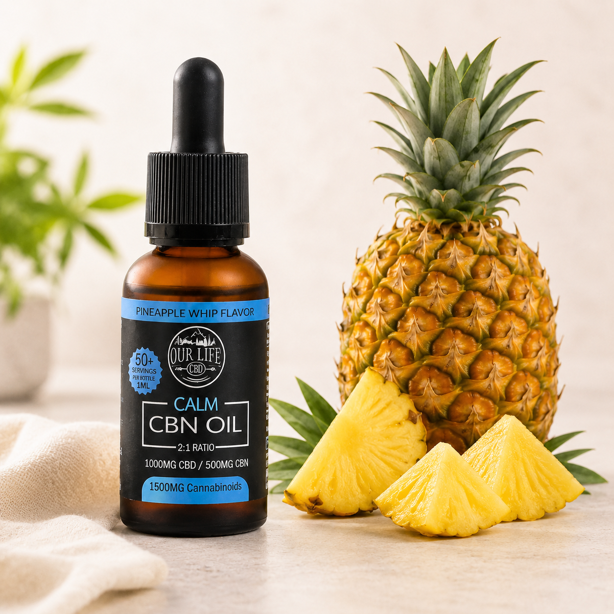An amber glass dropper bottle of NUR LIFE CBD CALM CBN OIL in Pineapple Whisk Flavor, styled next to a whole pineapple and three pineapple slices on a light beige surface with a soft neutral background.